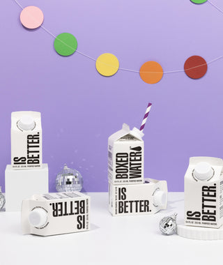 Mini Boxed Water cartons with garland, disco balls, and paper straw