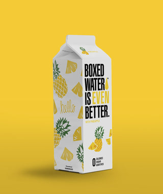 pineapple boxed water on a yellow background