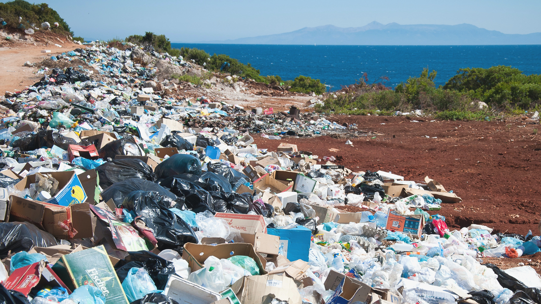 Large trash heap by dirt road 