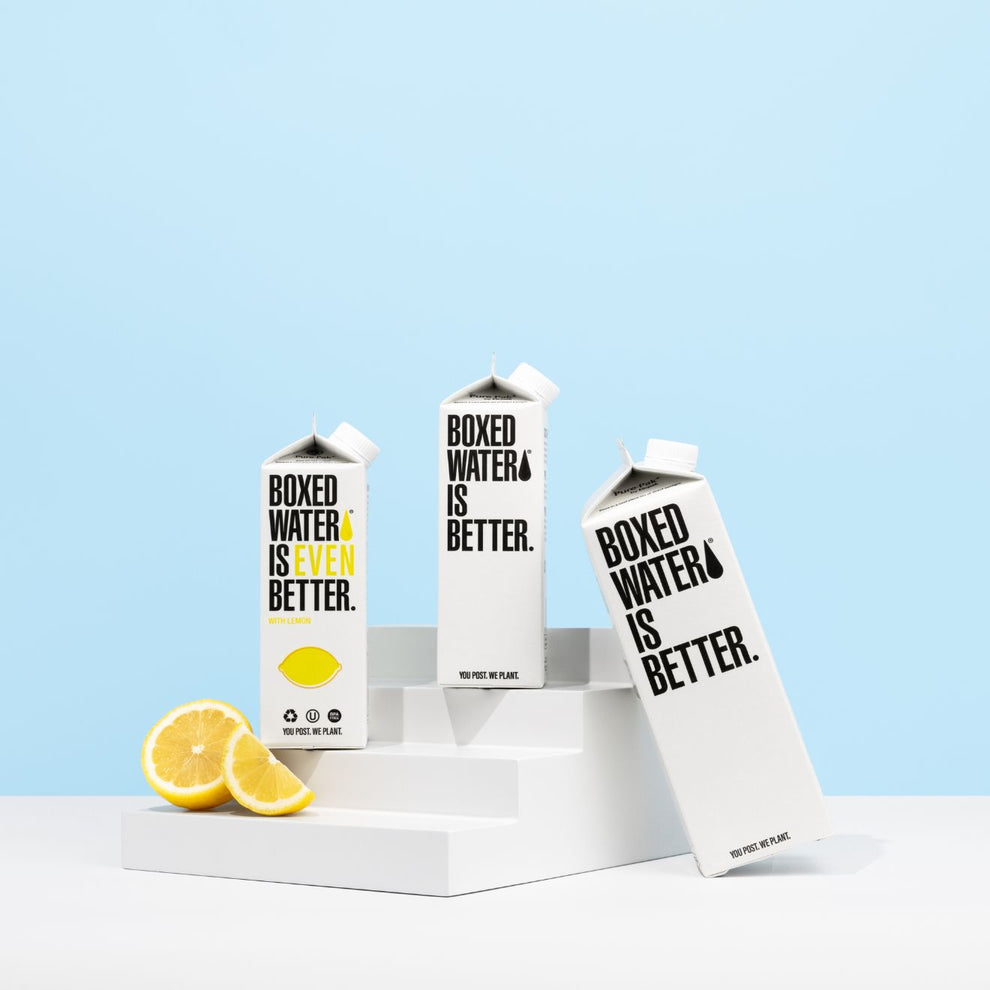 Lemon and original Boxed water and a sliced lemon on a mini staircase 