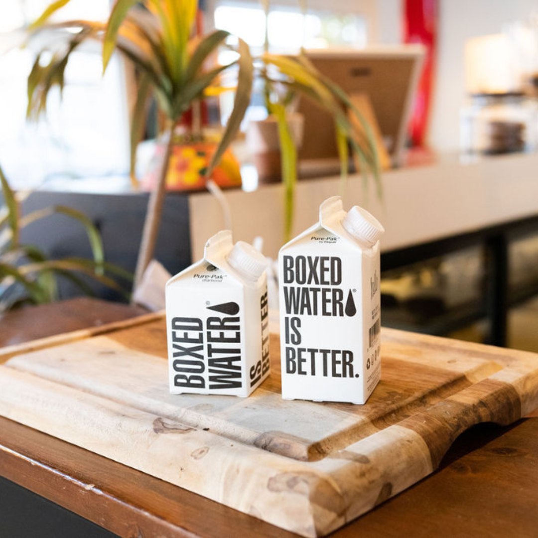 250ml and 330ml boxed water on a wood cutting board 