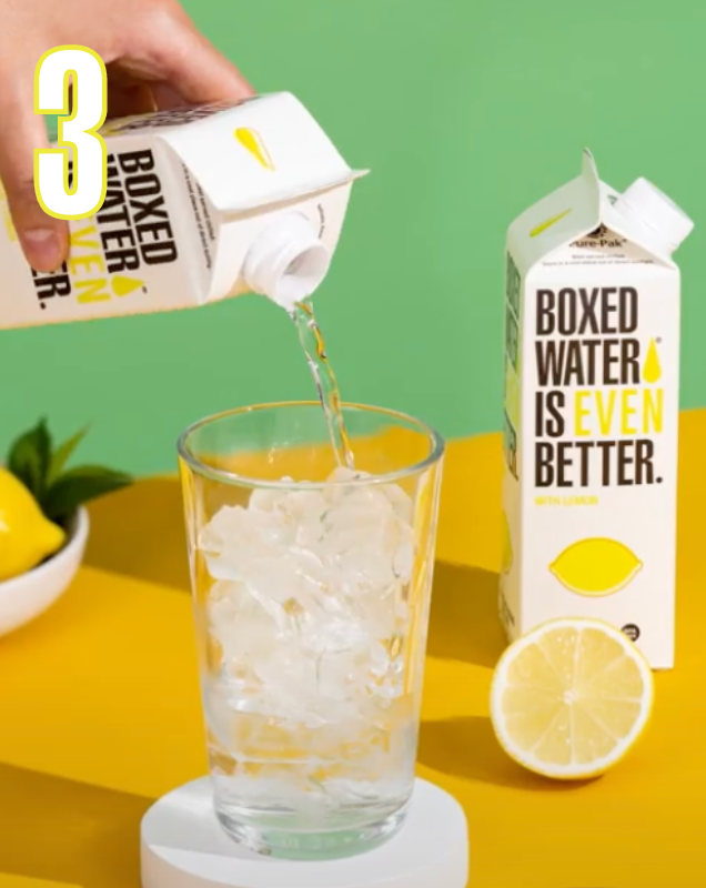 Number 3 with hand pouring lemon flavored Boxed Water into glass with ice