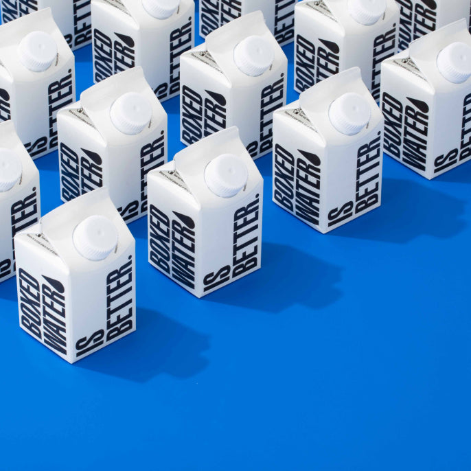 250ml Boxed Water cartons on blue background