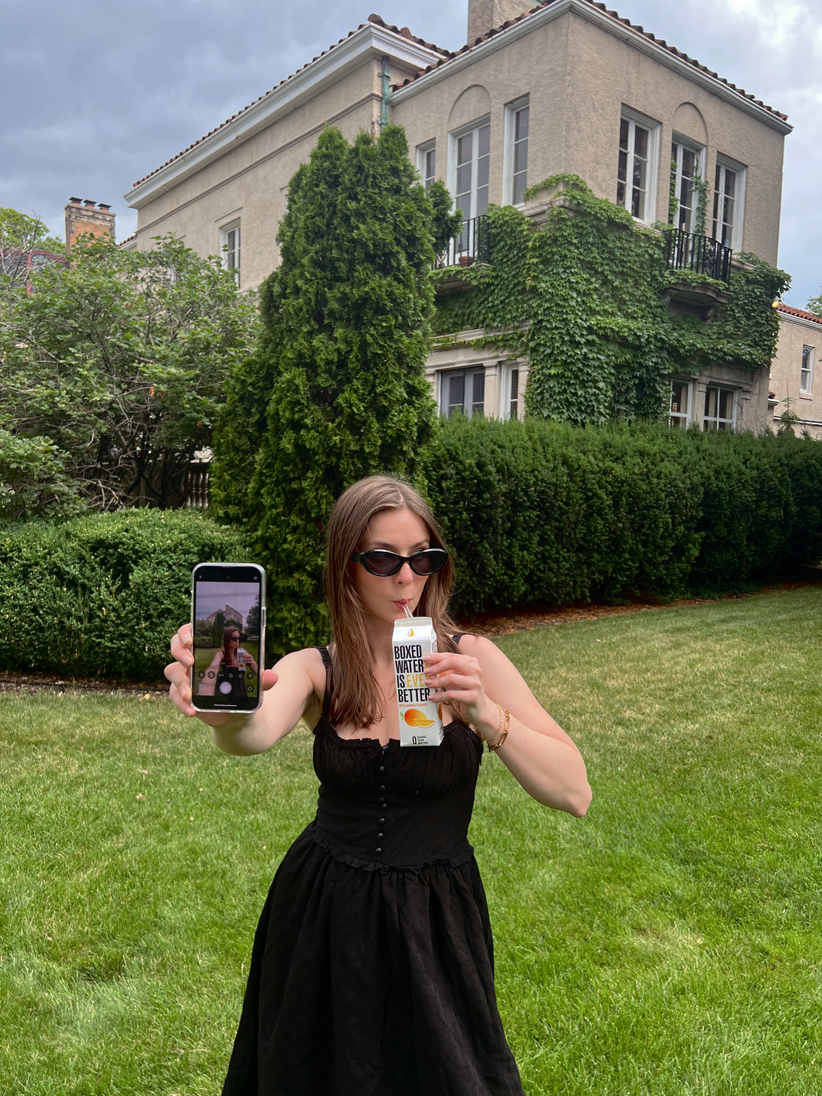 Girl drinking Boxed Water and taking selfie