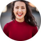 Young woman with wavy hair in red shirt