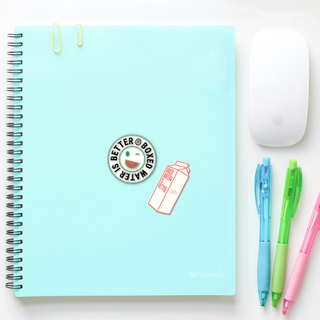 Notebook with Boxed Water Is Better stickers on it with pastel colored pens and mouse next to it