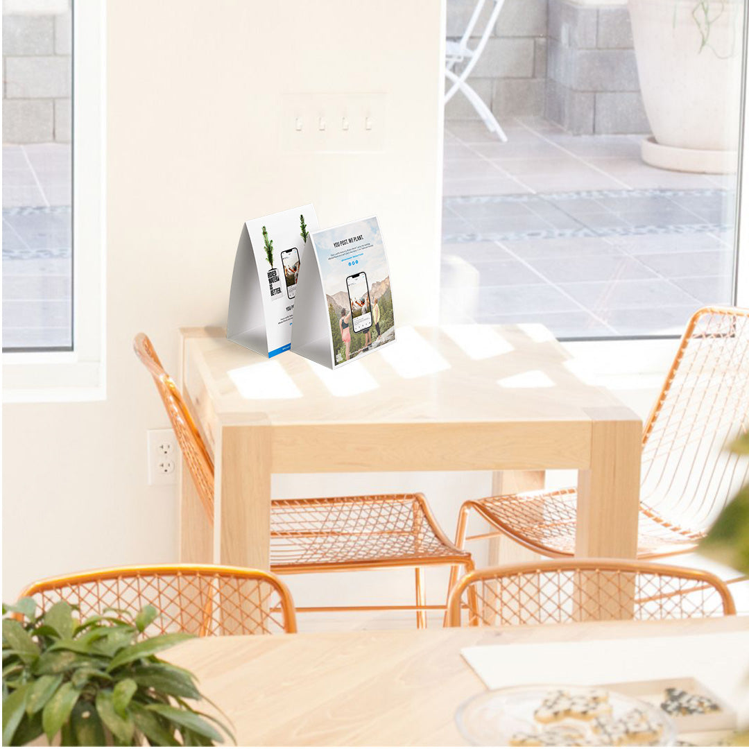 boxed water table tents on a table next to wall hangings