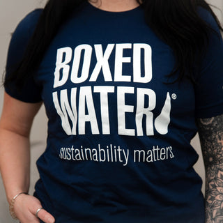 female wearing Boxed Water Sustainability Matters t-shirt wearing brown hat