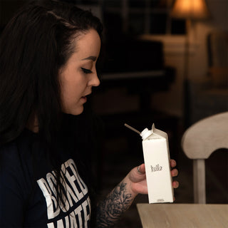 female sipping on boxed water is better carton with eco-friendly straw