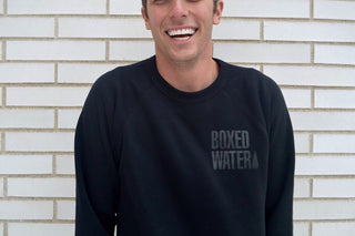 smiling man with black boxed water sweatshirt